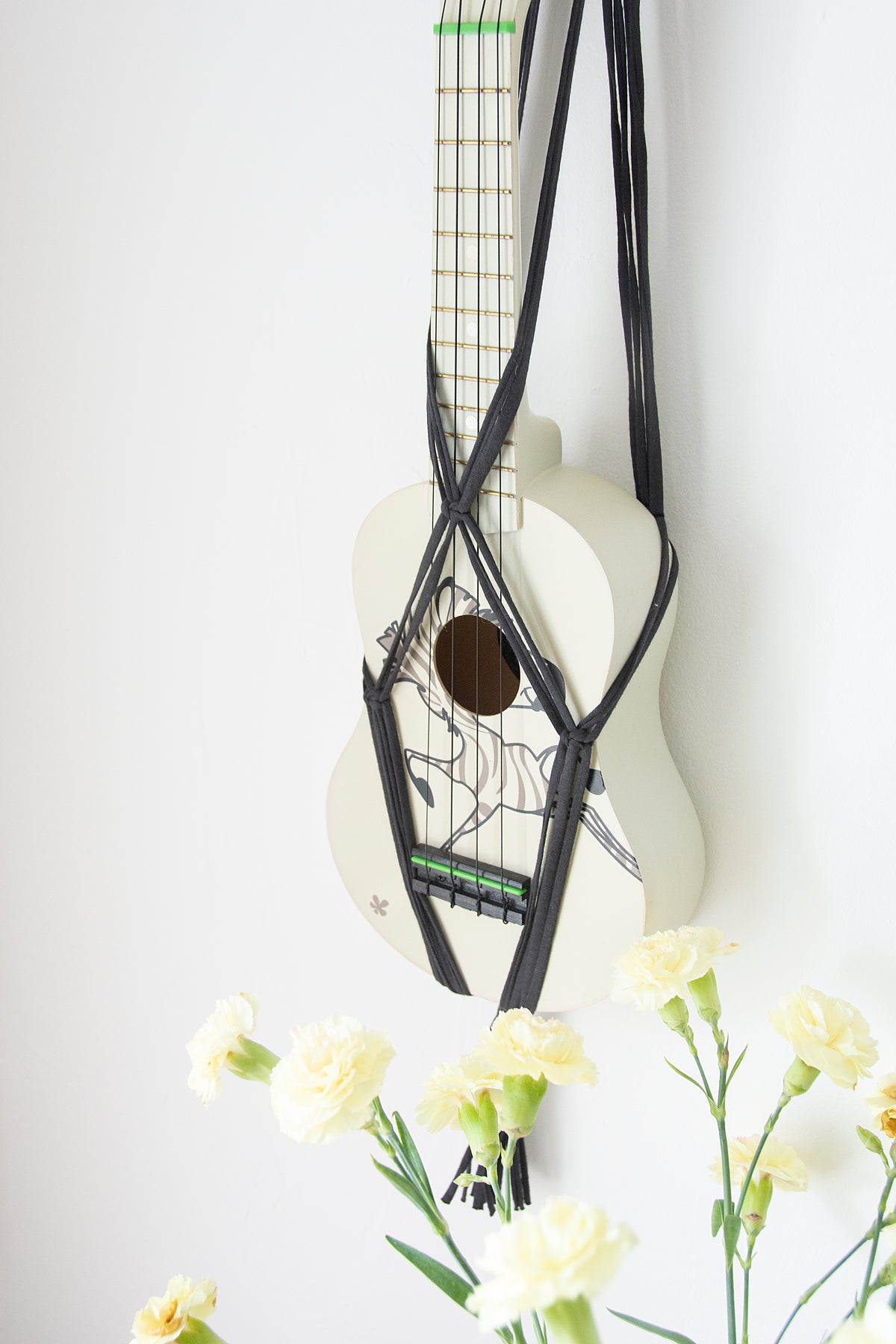 Grey hanger for ukulele